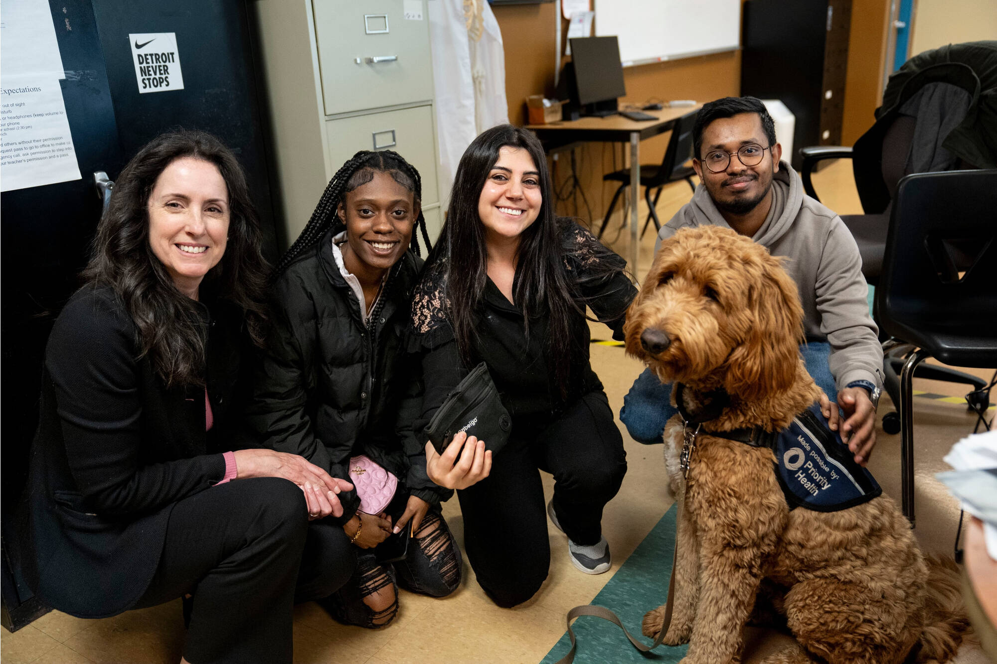 group of staff and students posing photo with Beau the dog